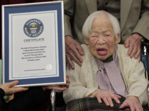 Japan's 114-year-old Misao Okawa poses with the Guinness World Records certificate of the world's oldest woman at a nursing home in Osaka, western Japan, Wednesday, Feb. 27, 2013. She has been recognized as the worlds oldest woman by Guinness World Records on Wednesday. (AP Photo/Itsuo Inouye)